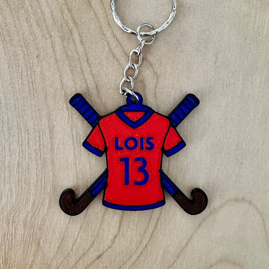 Personalised field hockey shirt keyring with crossed hockey sticks